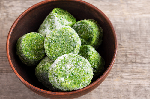 frozen spinach patties in a bowl