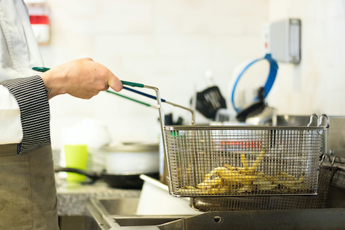 Frying basket preparing fries