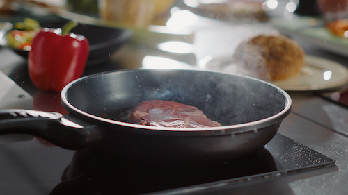 cooking in oil in a frying pan with smoke