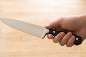 Hand testing the grip of a chef's knife